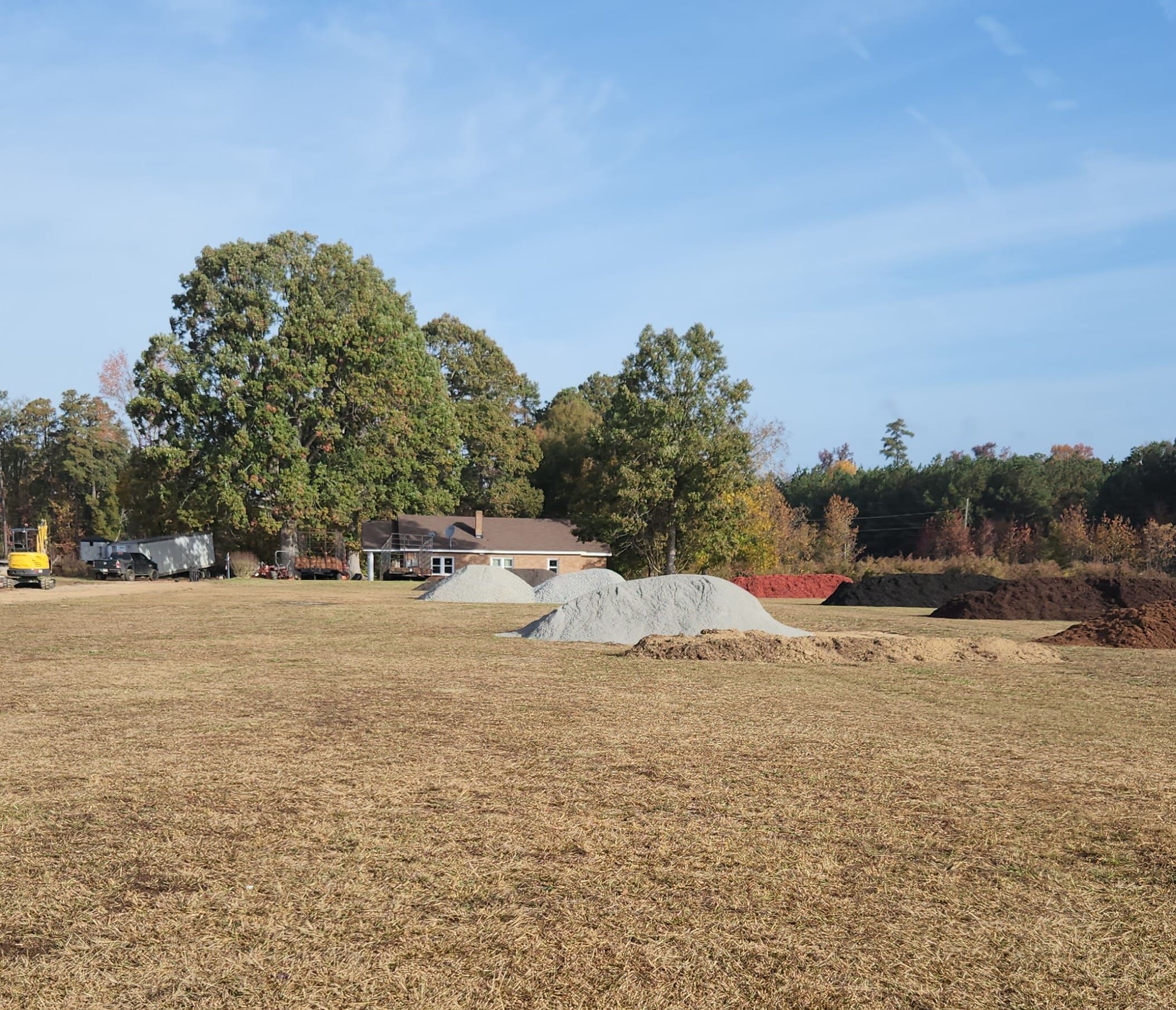 Yard with pine straw and stone pile
